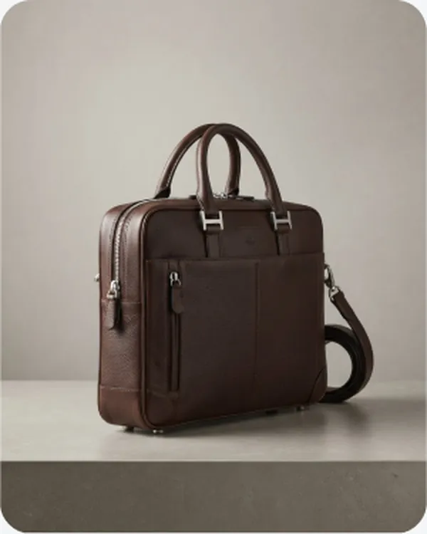 Dark leather briefcase on a plain ground